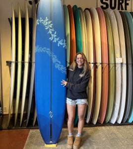 nya-standing-with-her-blue-surfboard