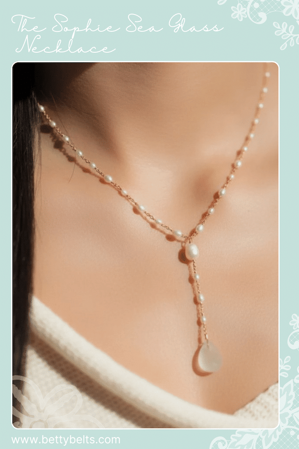 Delicate rose-gold tone chain necklace with evenly spaced pearls and a teardrop sea-glass pendant at the collarbone.